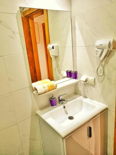 a bathroom with a sink and a mirror at Cozy apartment adana in Aourir