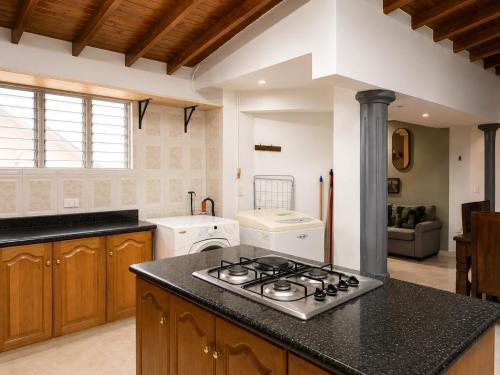 a kitchen with a stove top oven next to a counter at Coliving Compostela in Medellín