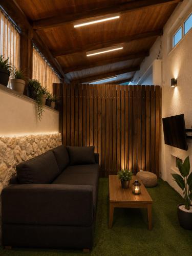 a living room with a couch and a table at יחידת נופש בעמק המעינות in Bet Sheʼan
