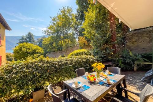 a table and chairs on a patio at Lenno Centrale in Lenno