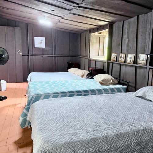 two beds in a room with two beds sidx sidx sidx sidx at La Cabaña de Don Tavo in Roble