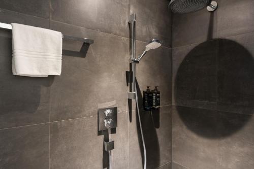 a bathroom with a shower with a shower head at Mercure Hotel Schiphol Terminal in Schiphol