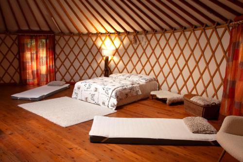 a bedroom with a bed in a yurt at Jurta Les Park in Vřesovice