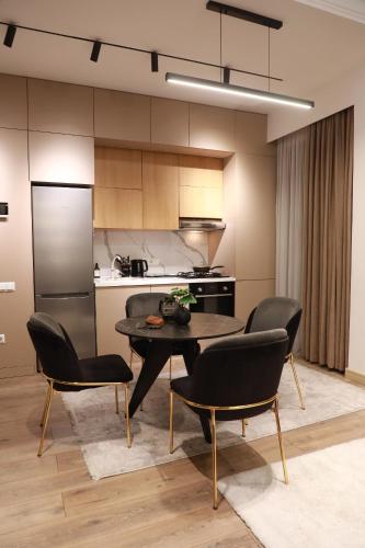 a kitchen with a table and chairs in a room at Tashkent city Gardens E2 block in Tashkent