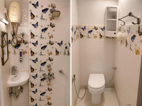two pictures of a bathroom with a toilet and a sink at Peaceful Studio with Kitchen in New Delhi