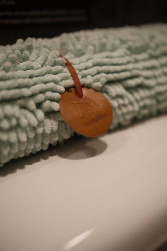 a close up of a blanket with a tag on it at Casa Oxidada in Puerto Natales
