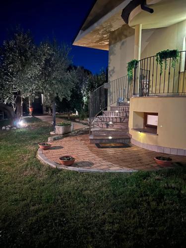 a house with a staircase and a porch at night at Villa MA-YA in Santa Maria Imbaro