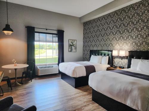a hotel room with two beds and a table at Waterfront Hotel in Prairie du Chien