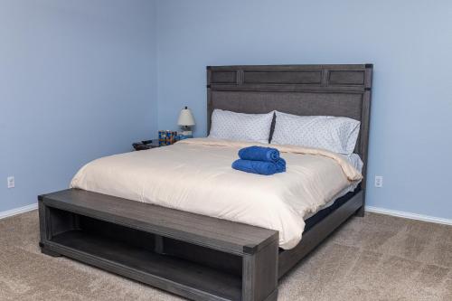 a bedroom with a large bed with a blue wall at Bluebonnet Retreat in Flower Mound