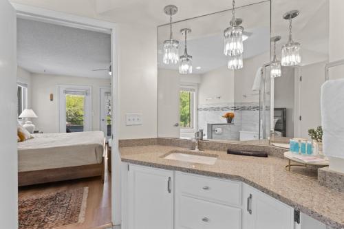 a bedroom with a bed and a large bathroom with a sink at Dells Paradise At Lighthouse Cove Condominiums in Wisconsin Dells