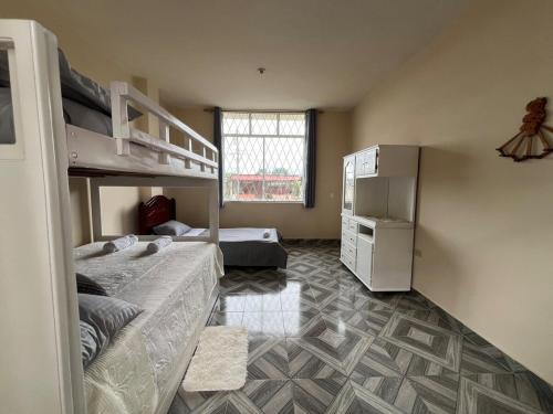 a bedroom with two bunk beds and a window at Aruma House - Departamento de 2 Dormitorios in Tena