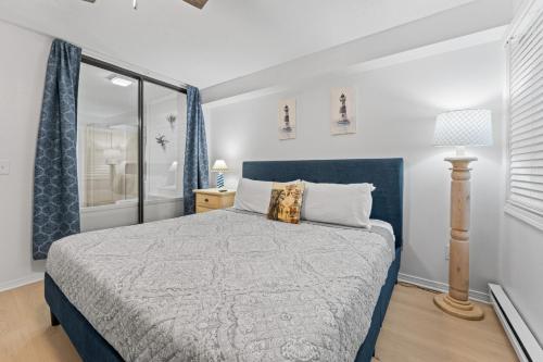 a bedroom with a bed with a blue headboard at Dells Suite Dreams At Lighthouse Cove Condominiums in Wisconsin Dells