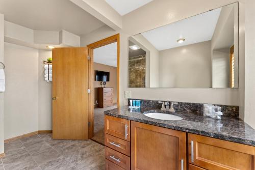 a bathroom with a sink and a mirror at Dells Family Stacation in Wisconsin Dells