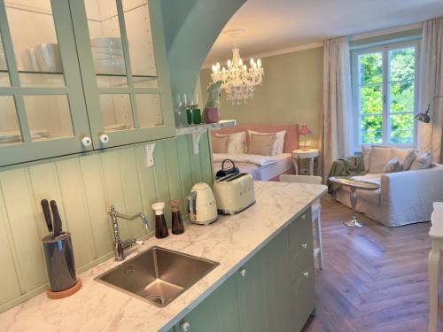 a kitchen with a sink and a living room at Villa Wickenburg in Salzburg