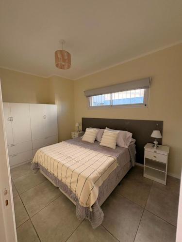 a bedroom with a large bed and a window at Punto San Martin in Venado Tuerto