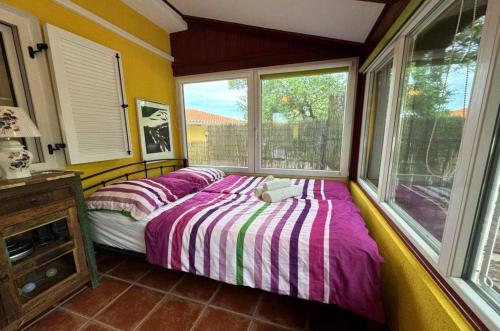 a bedroom with a bed in a room with windows at Villa Malnar in Vrh