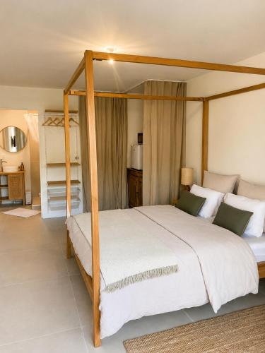 a bedroom with a large bed with a wooden frame at Chambre cosy in Viols en Laval