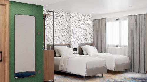 a bedroom with two beds and a mirror at Holiday Inn Express Yalova by IHG in Yalova