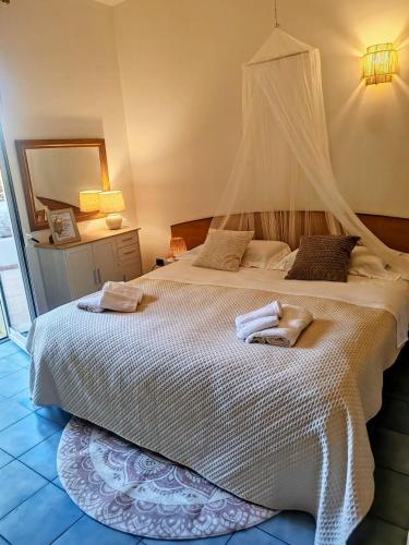 a bedroom with a bed with two towels on it at Salento Garden Relax in Merine