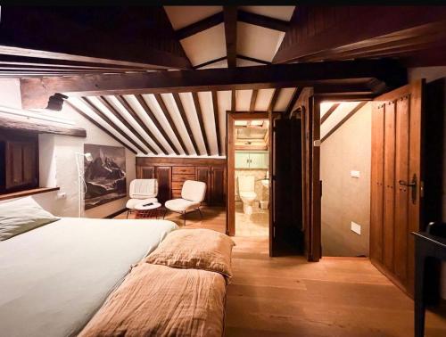 a bedroom with a bed and a chair in it at LITTLE TOWER in Potes