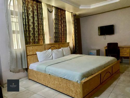 a bedroom with a large bed in a room at Luxritel Hotel Abuja in Kajewole