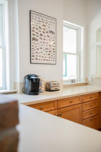 a kitchen counter with a toaster and a picture on the wall at Kid-Friendly Stay with Backyard: Long Stays in Salt Lake City