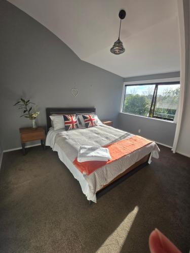 a bedroom with a large bed and a large window at Amore Manor Auckland in Auckland