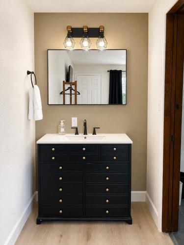 a bathroom with a sink and a mirror at Kiva Motel in Show Low