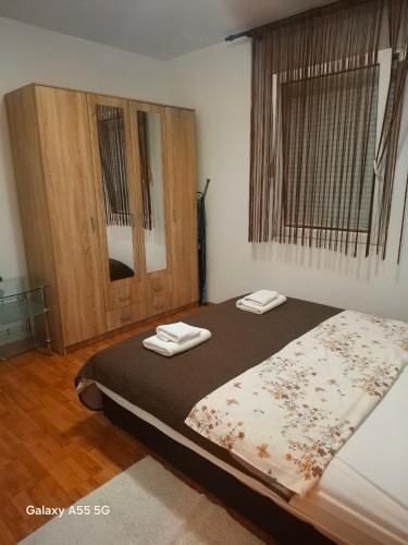 a bedroom with a bed with two towels on it at Macy in Kotor