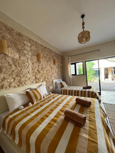 a large bedroom with two beds and a window at Kaouki paradise tafoukt in Essaouira