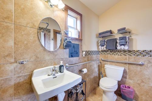 a bathroom with a sink and a toilet and a mirror at Cute Studio Cabin Steps to Long Beach Boardwalk in Long Beach