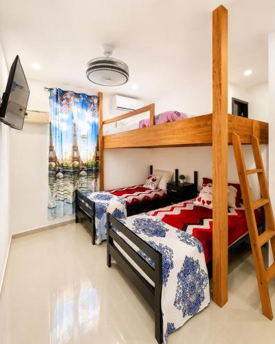 a bedroom with two beds and a bunk bed at Villa Spa Mega Relax in San Francisco de Macorís