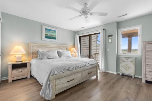 a bedroom with a bed and a ceiling fan at 1211 Creekwatch Villa in Seabrook Island