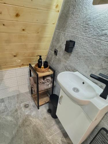 a bathroom with a white toilet and a sink at Forest Whisper Lux - A-frame cabin with private hot tub in Kovačka Dolina