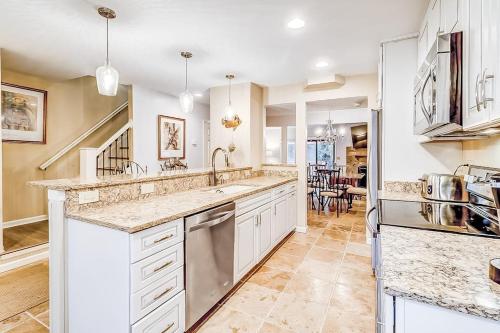 a kitchen with white cabinets and a counter top at Beachwalk 124 in Hilton Head Island