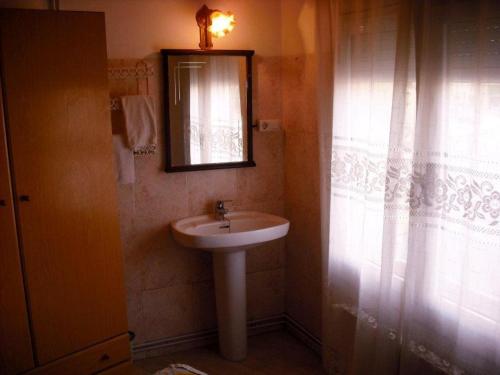 a bathroom with a sink and a mirror at Hostal Cassa in Cassà de la Selva