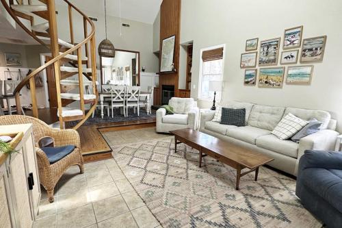 a living room with a couch and a table at Firefly Cottage in Edisto Beach