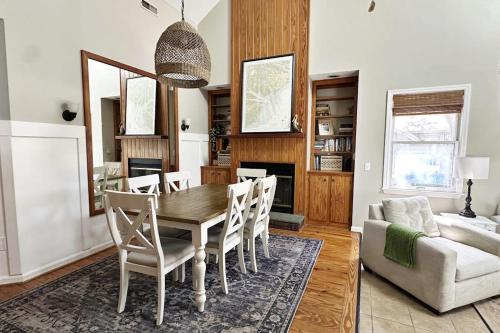 a dining room with a table and chairs and a couch at Firefly Cottage in Edisto Beach