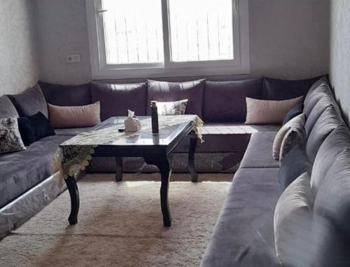 a living room with a couch and a coffee table at Cozy Appartement for vacation in Agadir