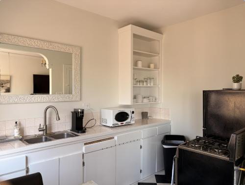 a kitchen with a sink and a microwave at The Vurpillat in Hermosa Beach