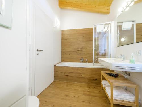 a bathroom with a tub and a sink and a shower at Hochkönigblick I in Werfenweng