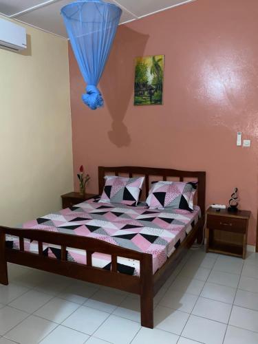 a bedroom with a bed with a blue balloon on the wall at CHEZ VERO Ziguinchor AGNACK in Ziguinchor