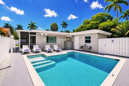 a swimming pool in the backyard of a house at Walk to Hollywood Beach Luxury 4BR Villa in Hollywood