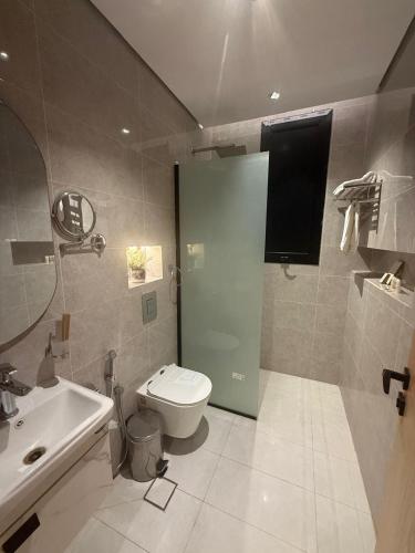 a bathroom with a toilet and a sink at Bright Moon in Al-ʿUla