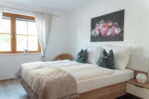 a white bedroom with a large bed with pillows at Pirkners Home in Sooss