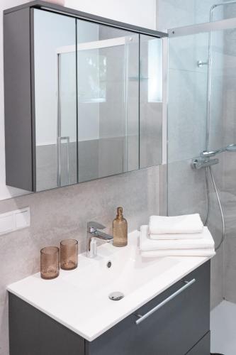 a bathroom with a sink and a mirror at Pirkners Home in Sooss