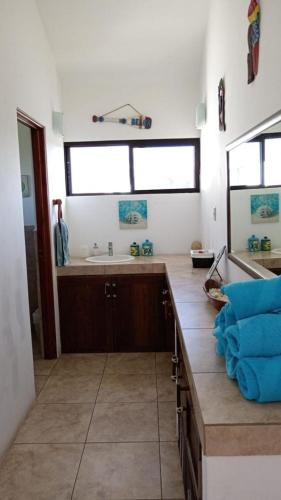 a kitchen with a sink and a counter top at Villa 24C Los Cabos Monterrico in Monterrico