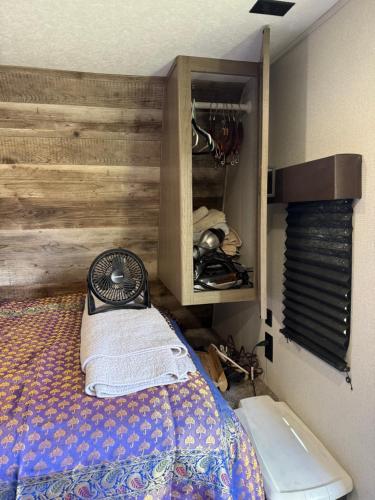 a bedroom with a bed and a wooden wall at Rv The Ark Camper in Hollywood