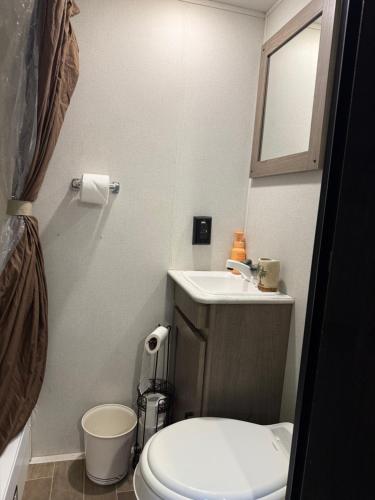 a bathroom with a white toilet and a sink at Rv The Ark Camper in Hollywood