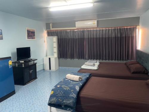 a bedroom with a large bed and a television at Dailyroom C3,C4by Anna in Nonthaburi